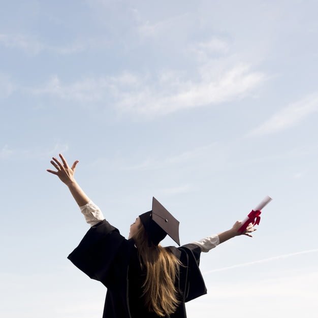 low angle young woman celebrating her graduation 23 2148505283