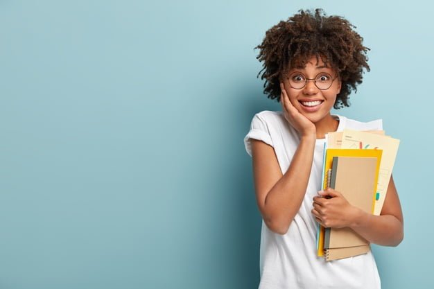 pleasant looking afro american woman holds notepads papers studies college glad finish studying 273609 26983
