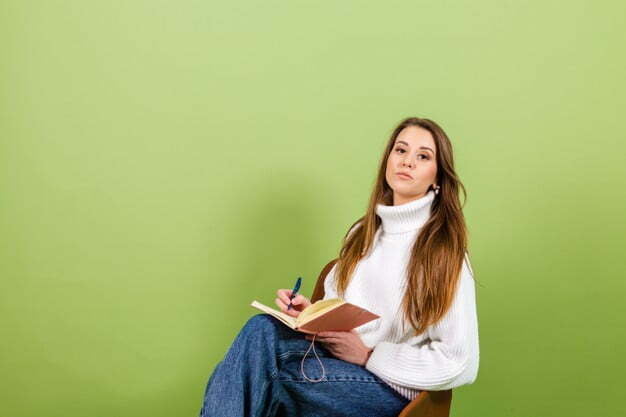 pretty european woman casual white sweater isolated cute happy sit chair with notepad pen 343596 4879