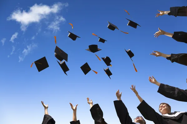 depositphotos 43013295 stock photo students throwing graduation hats in